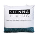 A bed dressed in white striped bedding and pillows showcases the Sienna Living Ultra Warm Winter Hungarian Goose Down Quilt, beside a wooden nightstand with a white mug and vase, set against a blue-gray wall and arched beige headboard.