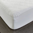 Close-up of the Sienna Living Premium Cotton Mattress Protector featuring a quilted cotton japara cover and diamond stitch pattern, fitted securely over a mattress with a grey upholstered base. Knit stretch skirt ensures a snug fit around corners.