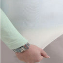 Close-up of the Sienna Living Premium Cotton Mattress Protector featuring a quilted cotton japara cover and diamond stitch pattern, fitted securely over a mattress with a grey upholstered base. Knit stretch skirt ensures a snug fit around corners.