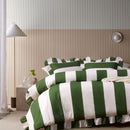 Bold green and white striped quilt cover with ruffle edge detail.