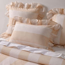 Natural striped cotton quilt cover with ruffle edges and matching pillowcases.