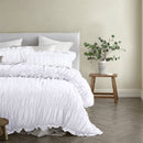 Crisp white cotton quilt cover with gathered detailing and pillowcases.