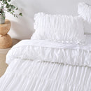Crisp white cotton quilt cover with gathered detailing and pillowcases.