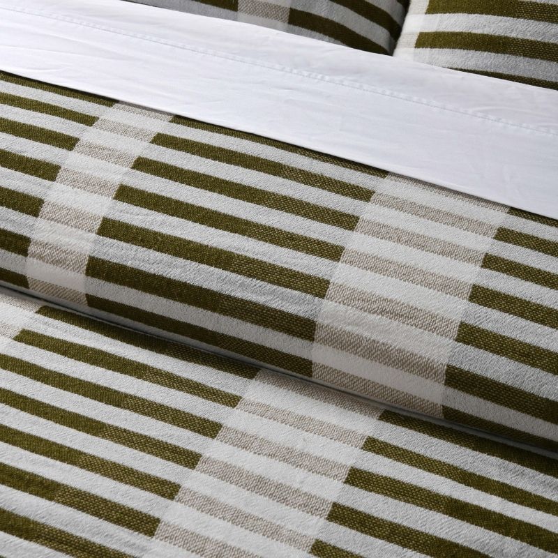 Close-up of Tempo green quilt cover fabric and stripe design.