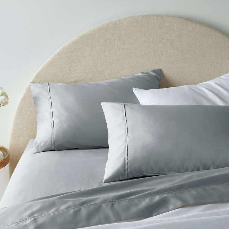 "A grey, superior-quality cotton sheet set in a cosy bedroom"