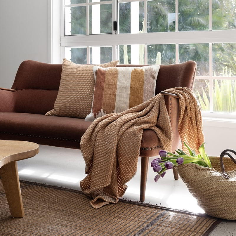 alt="Featuring a square cushion in two-tone light and dark brown waffle fabric in a earthy theme living space"