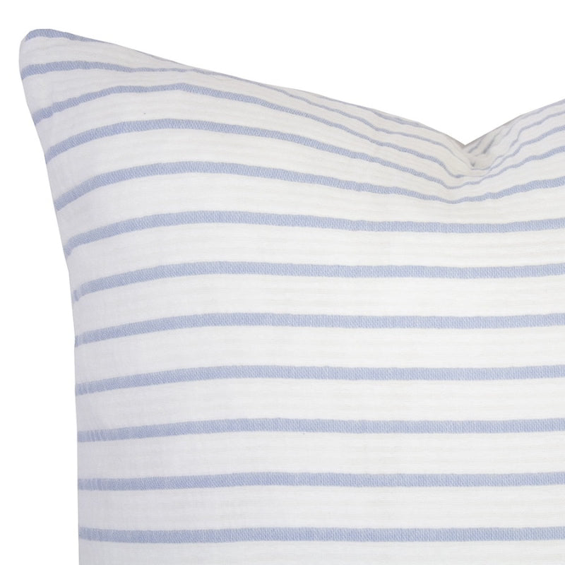alt="Close-up view of a striped white and blue cushion"