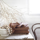 alt="Brown soft cotton bath towels in the wooden table"