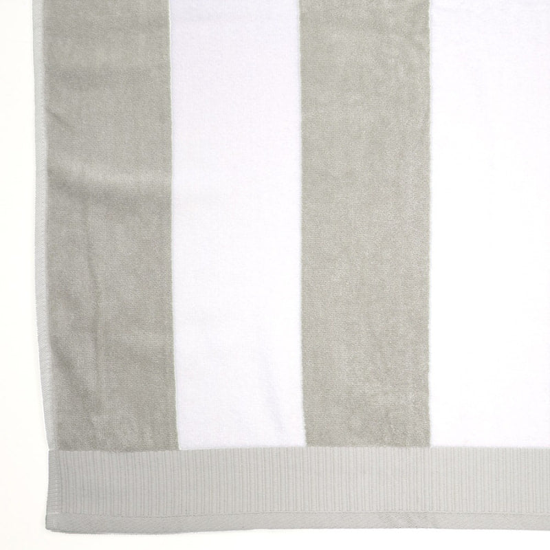 alt="Close-up view of a grey and white striped beach towel"