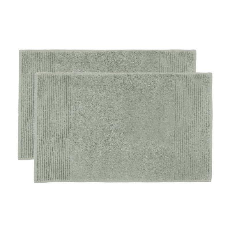 alt="Two beautiful, soft sage green cotton bath mats"