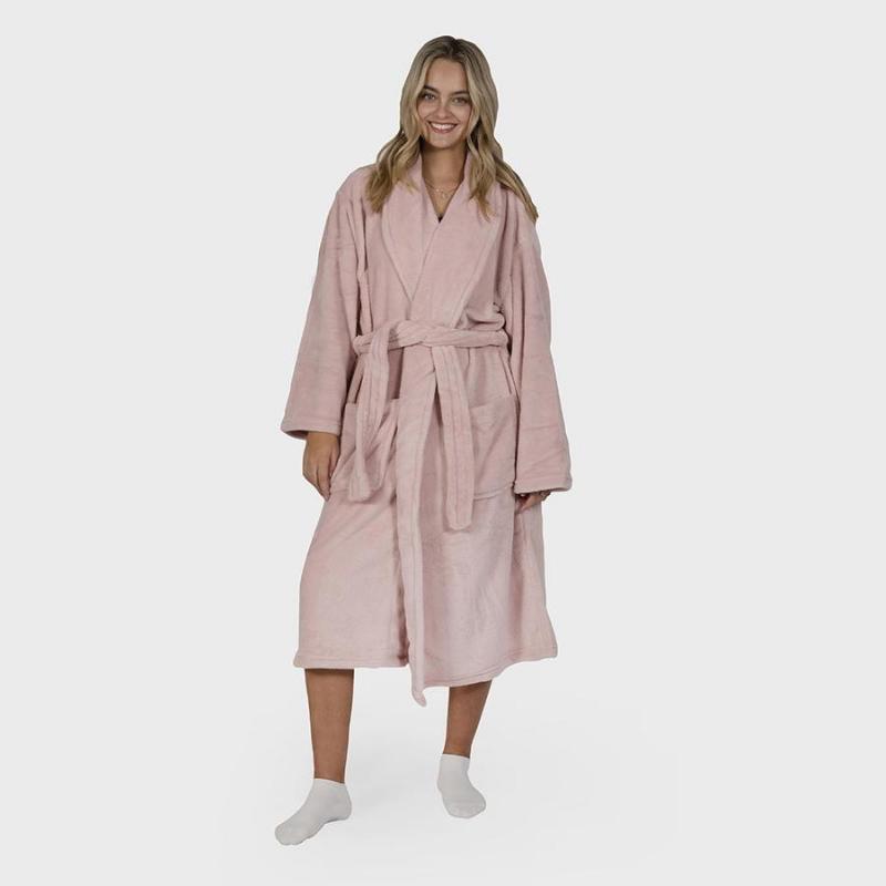 alt="A woman standing wearing a microplush pink robe"