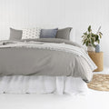 alt="Grey plain organic cotton quilt cover set in a minimalist style bedroom"