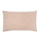 alt="Pink plain organic cotton pillow in a minimalist style bedroom"