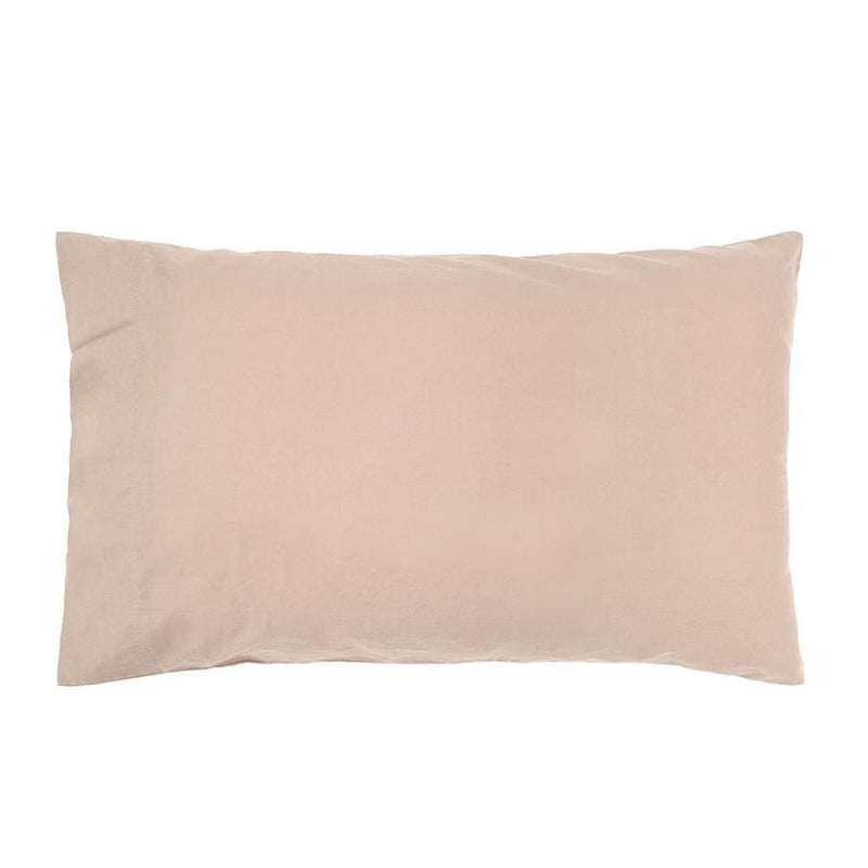alt="Pink plain organic cotton pillow in a minimalist style bedroom"