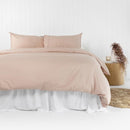 alt="Pink plain organic cotton quilt cover set in a minimalist style bedroom"