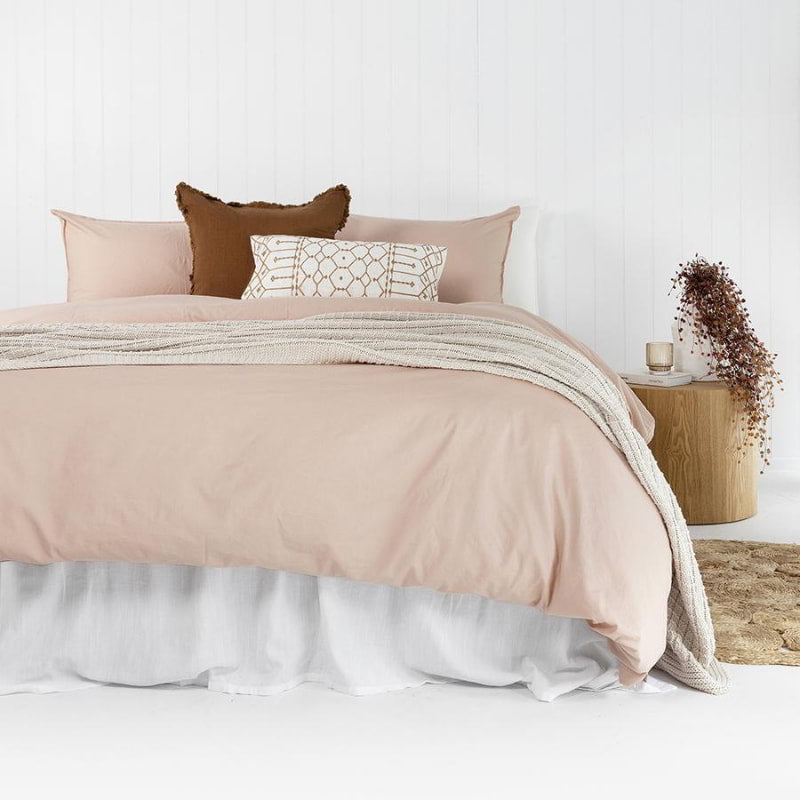 alt="Pink plain organic cotton quilt cover set in a minimalist style bedroom"