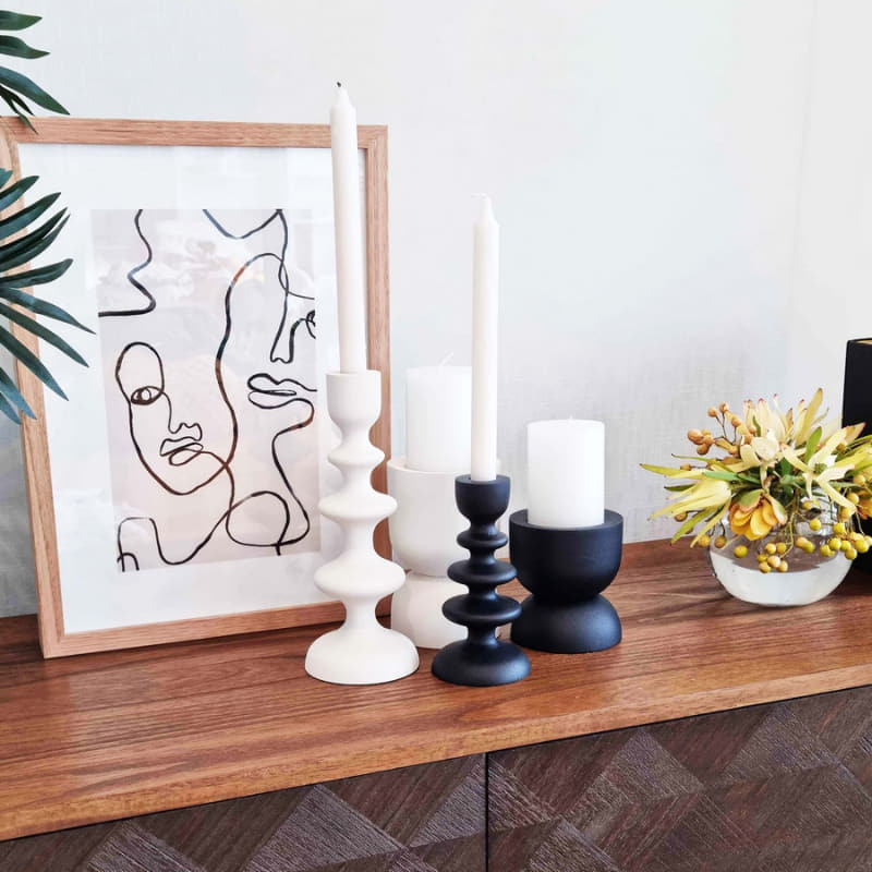 alt="A plain black candle holder in a living space"