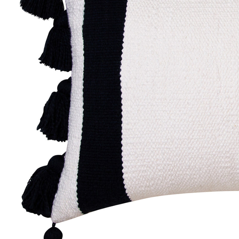 alt="Zoom in details of an ivory cushion featuring a block-coloured design with two thick solid black stripes and with two sides of chunky tassels"
