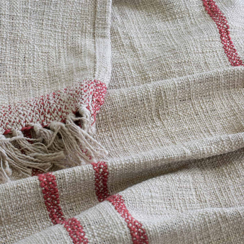 alt="Closer view of a Cassidy Throw with subtle stripe design, tassel accents"