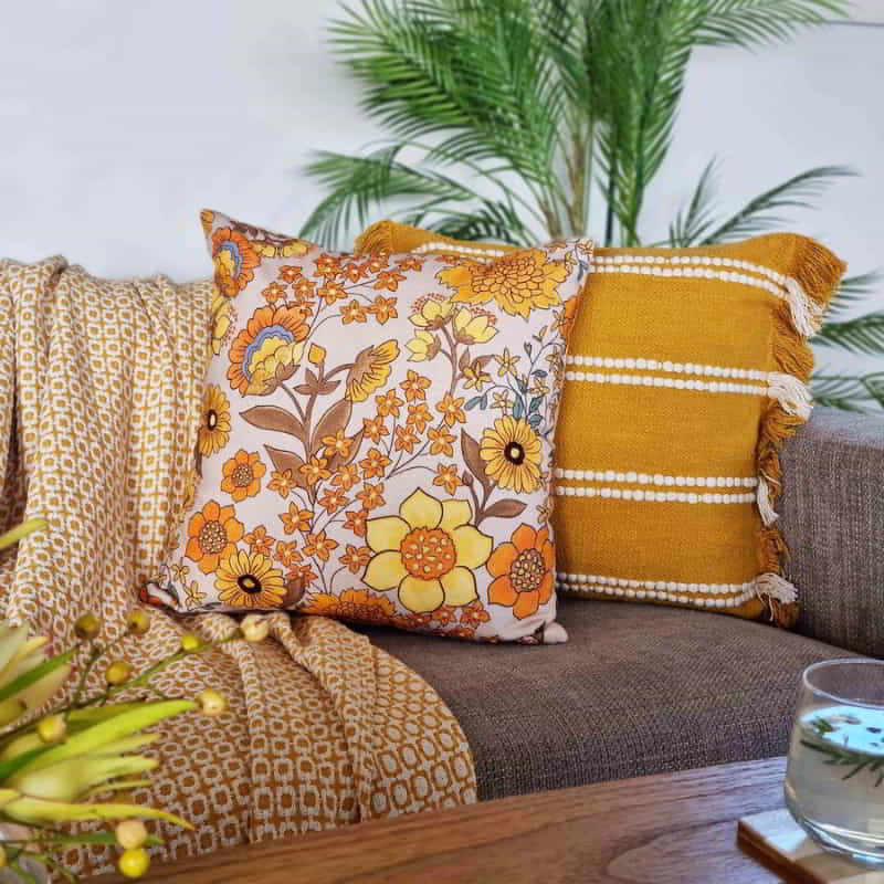 alt="A Mustard & Ivory Cushion adding a pop of colour to a contemporary living room