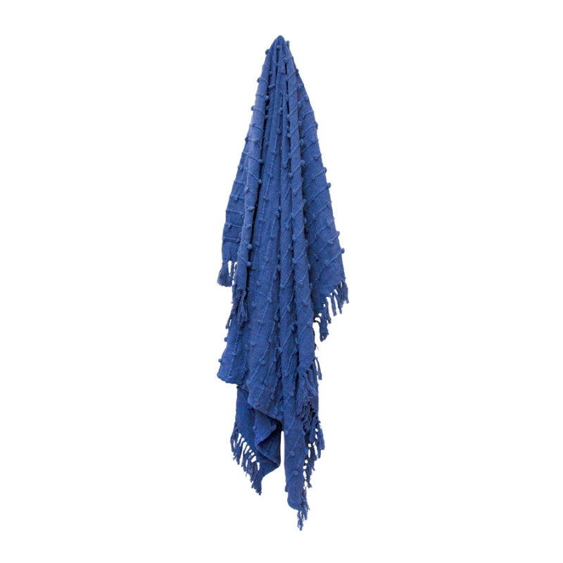 alt="A hanging textured solid colour throw with striped and looped stitching, adorned with tassels, in Blueberry hue."