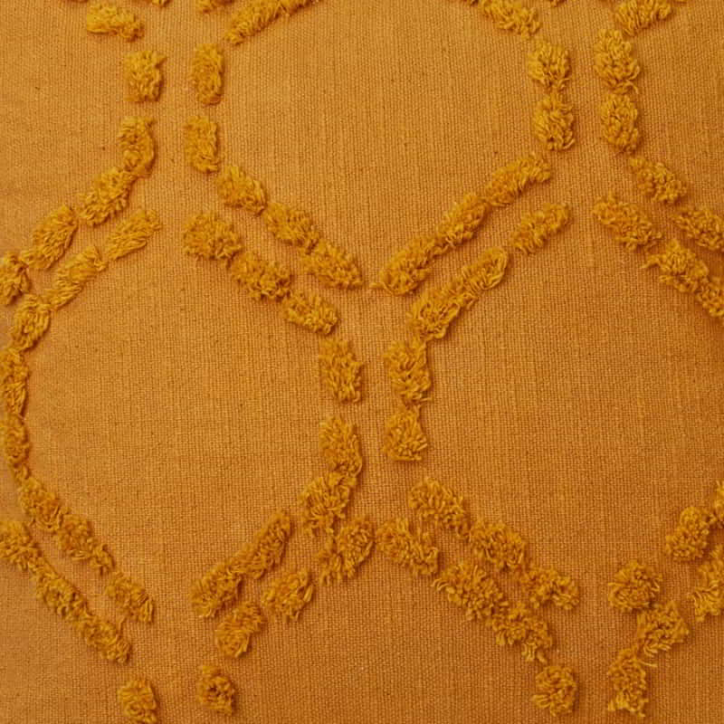 alt="Close details details of a yellow cushion featuring a hexagonal tufted design"