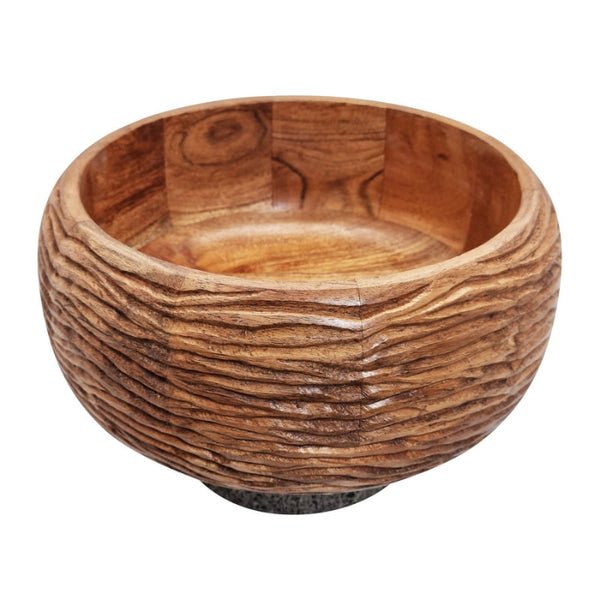 alt="A fruit bowl crafted from carved acacia wood for a touch of texture, the bowl rests upon a slap of terrazzo pairing beautifully with the brown tones of the acacia."