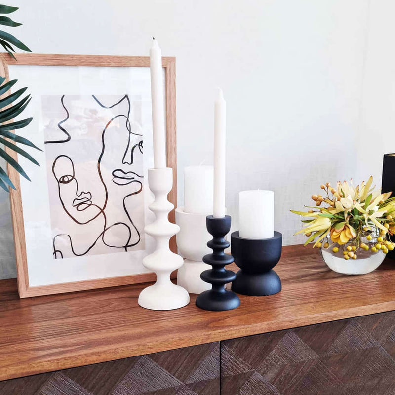 alt="A white candle holder in a living area"