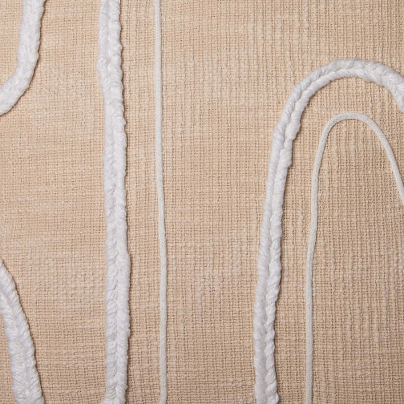 alt="Closer details of a natural cushion featuring a curved white cotton braids."