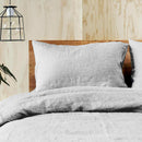 A serene bed featuring the quilt cover set of Jenny Mclean, highlighting the charm of linen bedding.