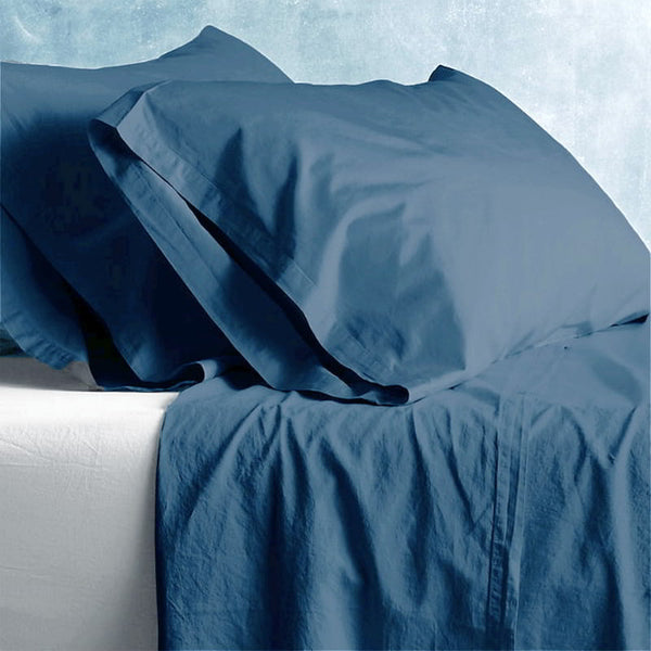 alt="A blue plain sheet set featuring an ultra-soft, velvety texture in a luxurious bedroom"
