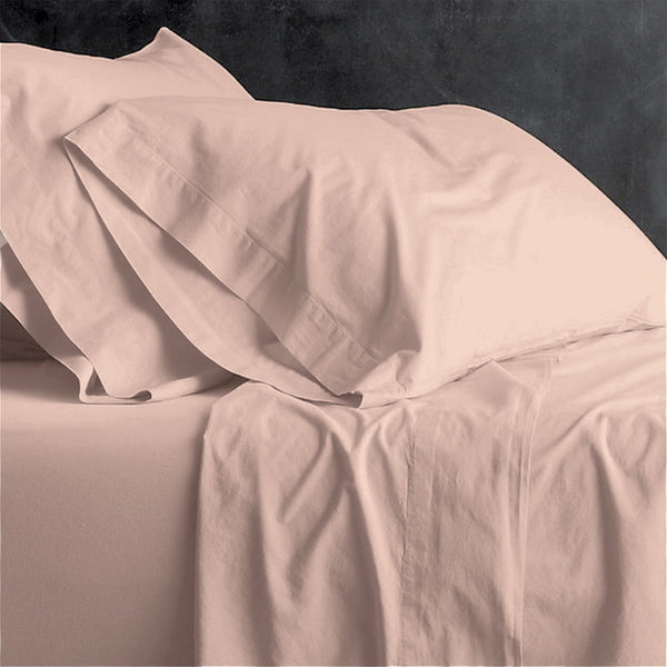 alt="A pink plain sheet set featuring an ultra-soft, velvety texture in a luxurious bedroom"