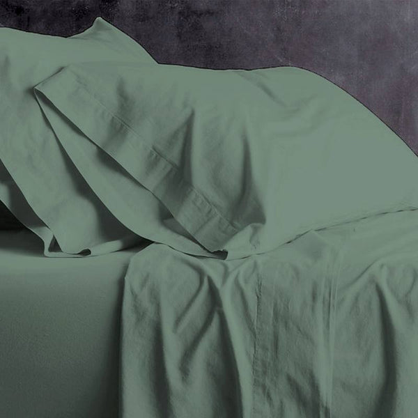 alt="A green plain sheet set featuring an ultra-soft, velvety texture in a luxurious bedroom"