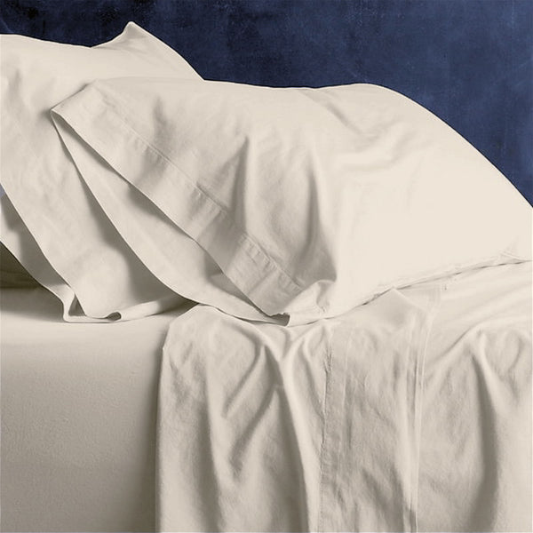 alt="A shade of stone plain sheet set featuring an ultra-soft, velvety texture in a luxurious bedroom"