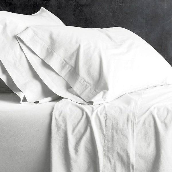 alt="A white plain sheet set featuring an ultra-soft, velvety texture in a luxurious bedroom"