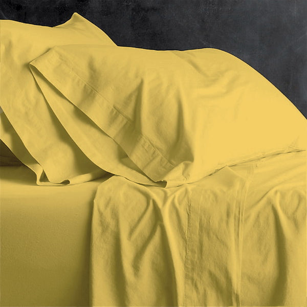 alt="A yellow plain sheet set featuring an ultra-soft, velvety texture in a luxurious bedroom"