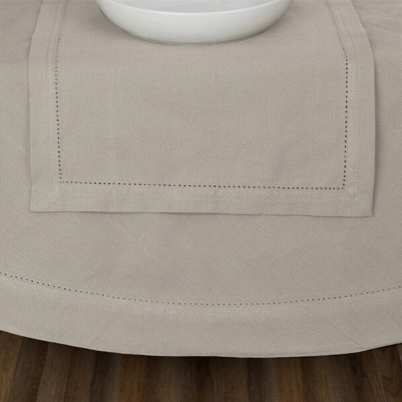 A table featuring a white bowl, complemented by an elegant oatmeal tablecloth, creating a sophisticated dining atmosphere.
