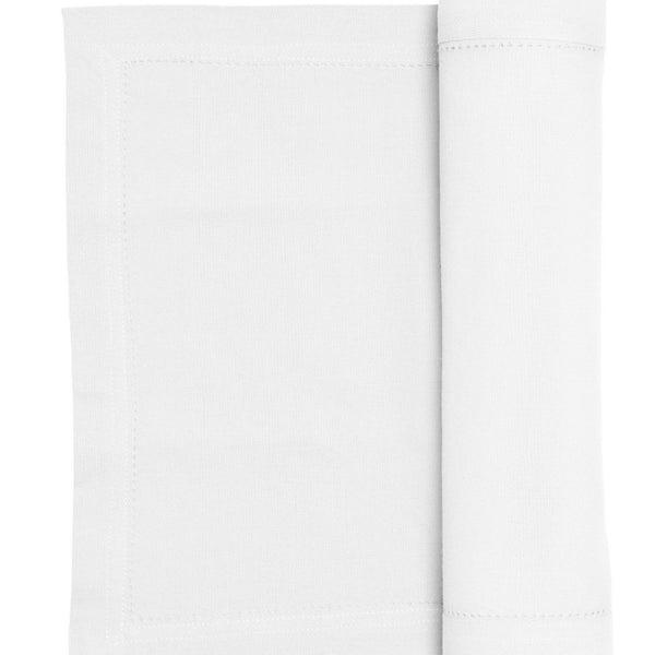A white runner elegantly folded, enhancing the sophistication of the dining experience.