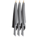 Three grey tea towels hanging on clothes pegs, showcasing their vibrant color and practical design for kitchen use.