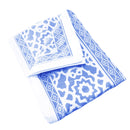 A neatly folded indigo tablecloth, showcasing its smooth texture and elegant style.