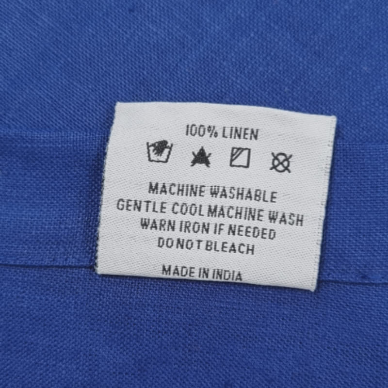 Showcasing back of the tag by RANS Cambrai Linen White Tea Towels set of 3 offers superior absorbency and style, softening with each wash for kitchen elegance.