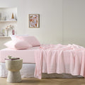 alt="A pink sheet set is lightweight, breathable and keeps cosy in winter"
