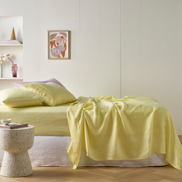 alt="A light yellow sheet set is lightweight, breathable and keeps cosy in winter"