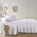 alt="A white sheet set is lightweight, breathable and keeps cosy in winter"