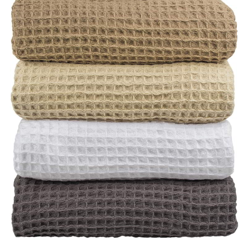 alt="Various colours of classic waffle weave pattern cotton blankets"
