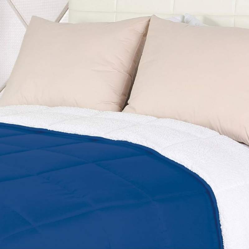 Close up details of the luxurious navy blue comforter which is perfect for a cosy and stylish bedroom.