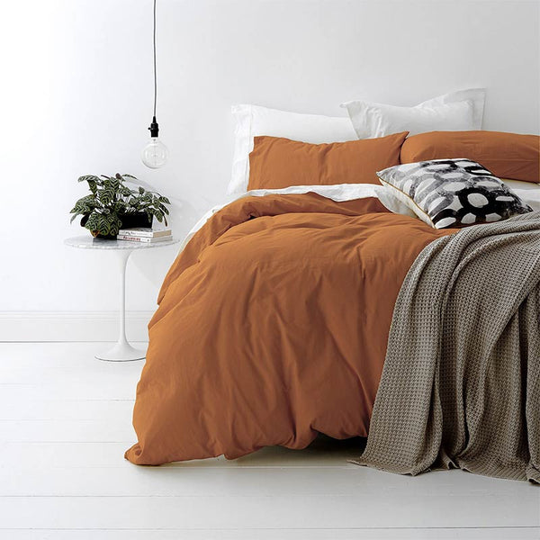 alt="A shade of orange quilt cover is soft, stylish percale bedding set made of fine cotton percale. Timeless design for modern bedrooms."
