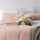 alt="A cosy bed with pink quilt cover and pillows, adorned with the Vintage Washed Cotton Blush Quilt Cover Set for a stylish and comfortable bedroom."