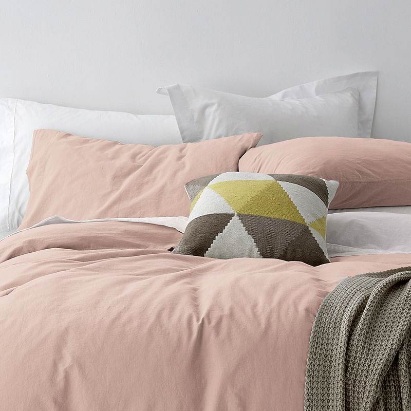 alt="A cosy bed with pink quilt cover and pillows, adorned with the Vintage Washed Cotton Blush Quilt Cover Set for a stylish and comfortable bedroom."